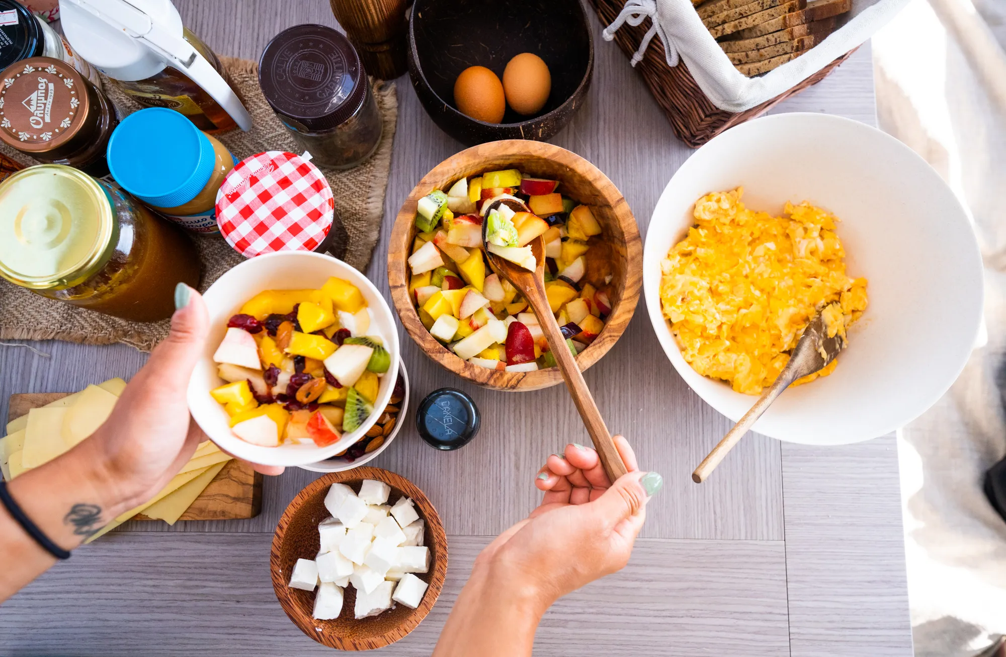 Breakfast on board: fresh fruit, scrambled eggs, cheese and bread on the table.