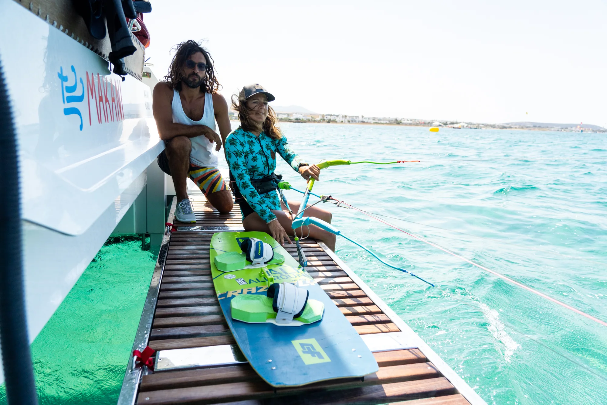 Kitesurfer launching directly from the Makani catamaran into the open water.